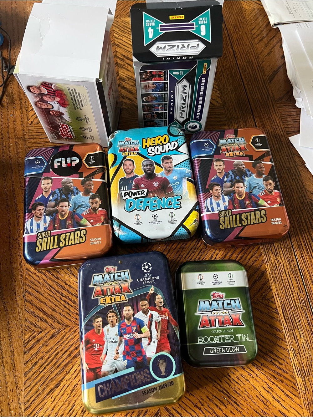 Assortment of Soccer CardTopps Match Attax Tin Set in Blue, Green, Orange, Black